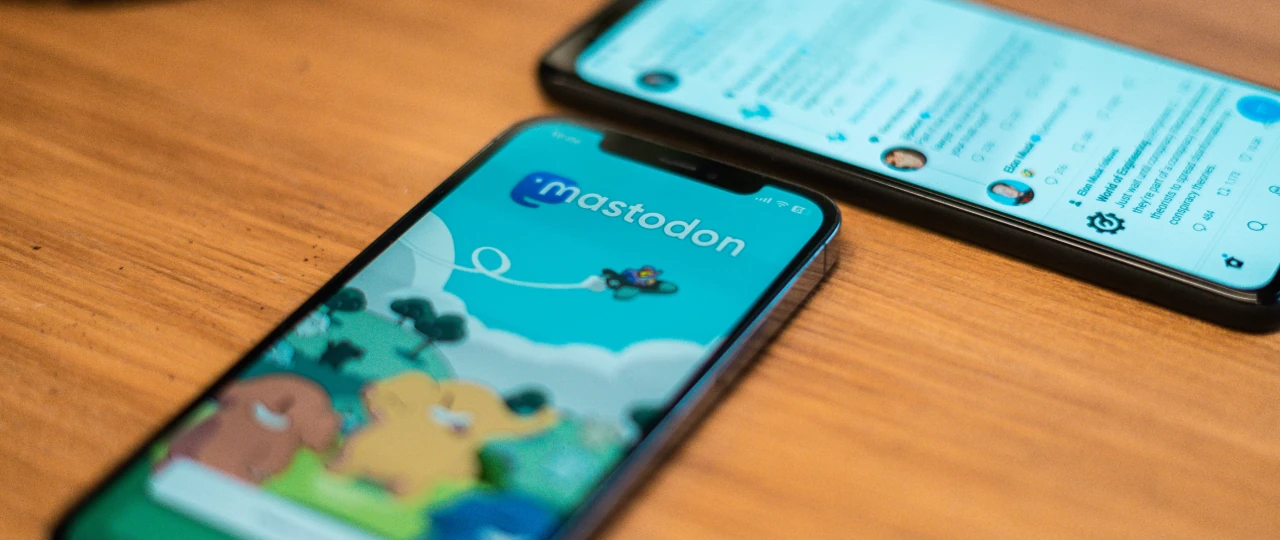 A phone on a table with a Mastodon app open
